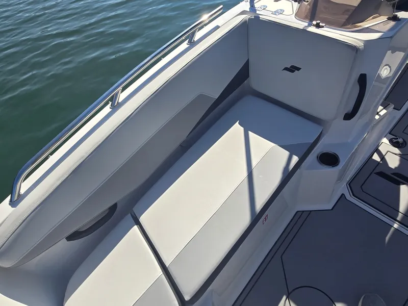Slide: The Image of The image shows a white seating area on a boat, surrounded by water. - 19