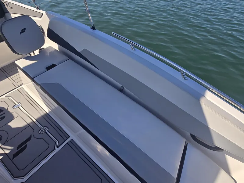 Slide: The Image of The image shows the deck of a 2027 Starcraft 181SVOB boat with gray upholstery. - 17