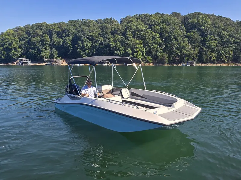 Slide: The Image of A modern 2027 Starcraft 181SVOB on a calm lake with a wooded shoreline. - 3