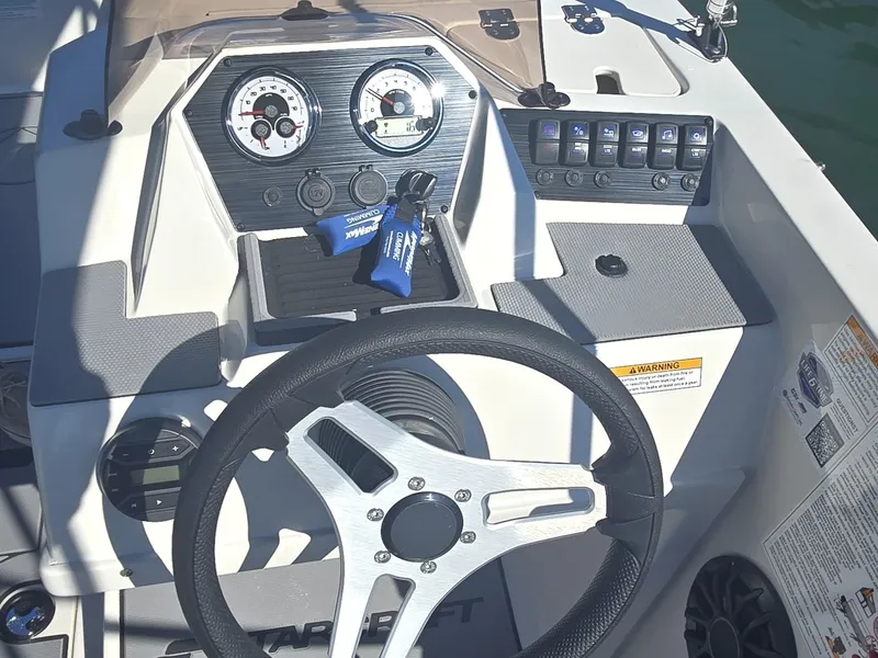 Slide: The Image of The image shows the helm of a Starcraft 181SVOB boat with modern instruments and controls. - 12