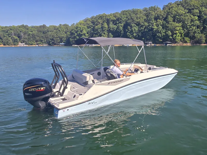 Slide: The Image of A 2027 Starcraft 181SVOB boat on a calm lake, featuring a Yamaha outboard motor. - 25