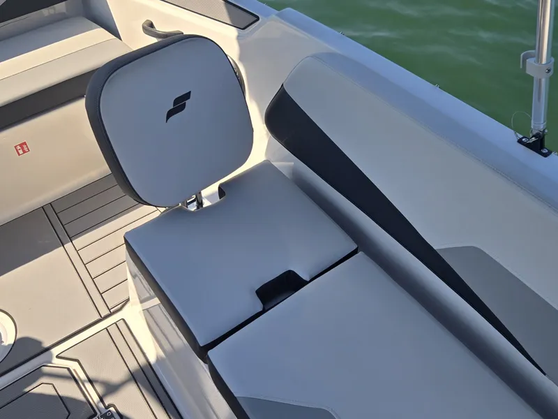 Slide: The Image of A modern seating area on a Starcraft 181SVOB boat, featuring gray and white upholstery. - 16