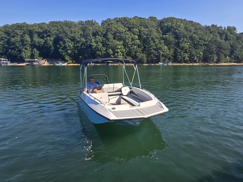 Slide: The Image of A 2027 Starcraft 181SVOB boat on a calm lake with a wooded shoreline. - 26
