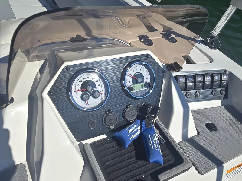 Slide: The Image of The dashboard of a 2027 Starcraft 181SVOB boat with gauges and switches. - 13