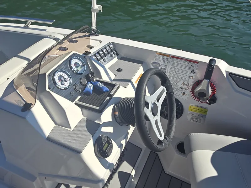 Slide: The Image of The image shows the helm of a 2027 Starcraft 181SVOB boat with modern instruments. - 11