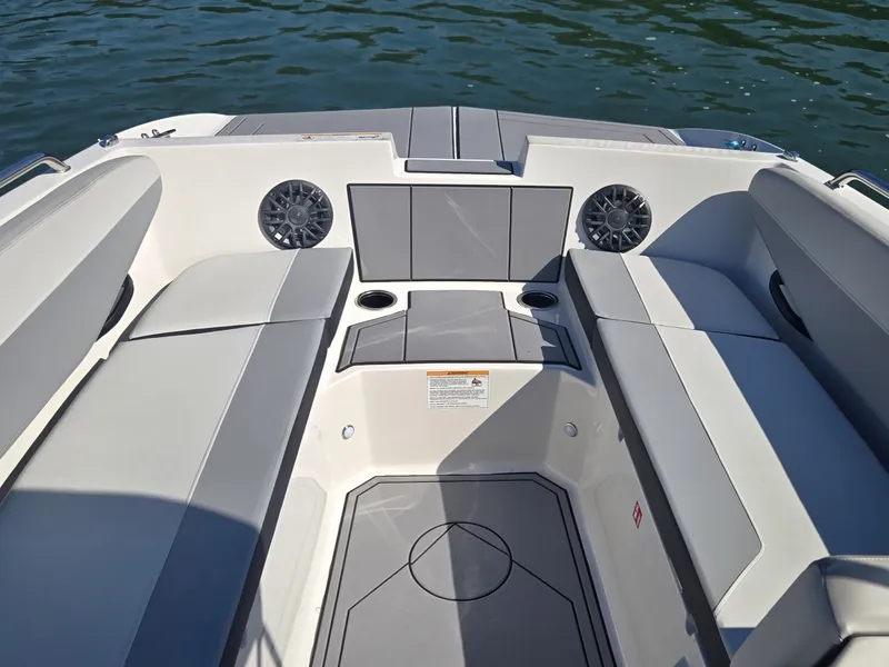 Slide: The Image of The image shows the cockpit of a 2027 Starcraft 181SVOB boat with gray upholstery and speakers. - 21