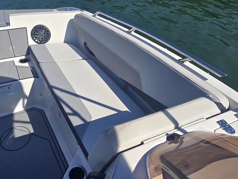 Slide: The Image of The image shows the cockpit of a 2027 Starcraft 181SVOB boat with white upholstery. - 18