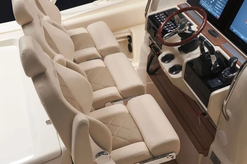 Slide: The Image of Manufacturer Provided Image: 2018 Chris-Craft Catalina 34 helm with luxurious beige seating and advanced navigation controls. - 4