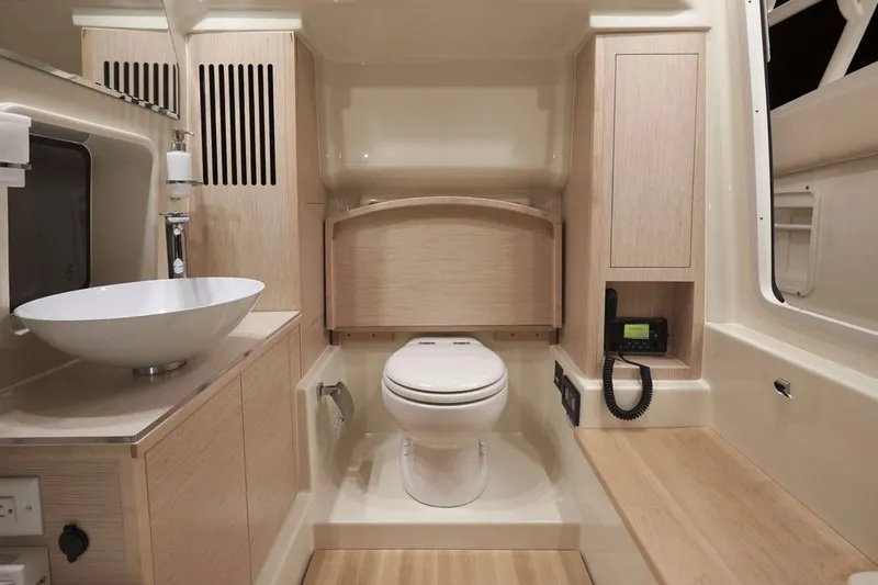 Slide: The Image of Manufacturer Provided Image: 2018 Chris-Craft Catalina 34 bathroom with modern fixtures and wooden cabinetry. - 8