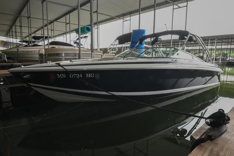 The Image of 2005 Cobalt 262 boat docked in a covered marina, side view. - 1