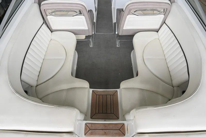 Slide: The Image of Interior of a 2005 Cobalt 262 boat featuring white leather seating and wooden accents. - 14