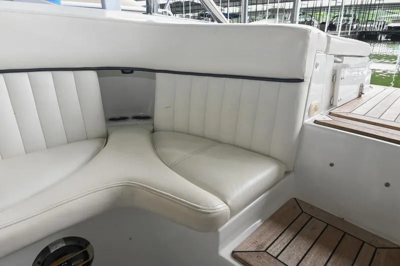 Slide: The Image of Interior seating of a 2005 Cobalt 262 boat with white upholstery and wooden flooring. - 21