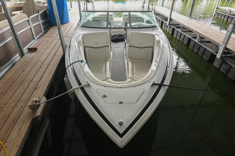 Slide: The Image of 2005 Cobalt 262 boat docked in marina, featuring white interior and sleek design. - 3