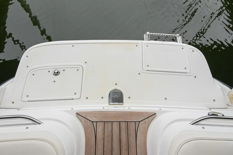 Slide: The Image of 2005 Cobalt 262 boat deck with teak accents and water reflection. - 7
