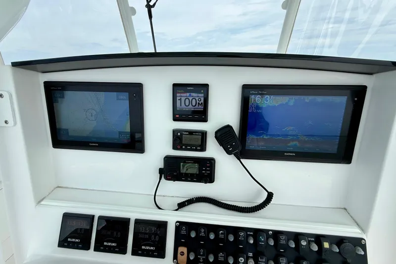 Slide: The Image of Cockpit view of 2017 Southport 33 FE boat navigating open waters. - 14