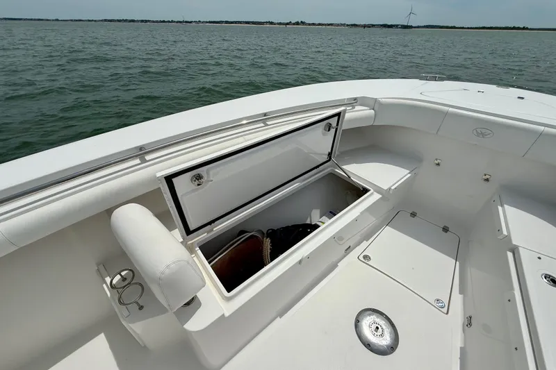 Slide: The Image of 2017 Southport 33 FE boat with open storage compartment, life jackets, and safety gear bag. - 18