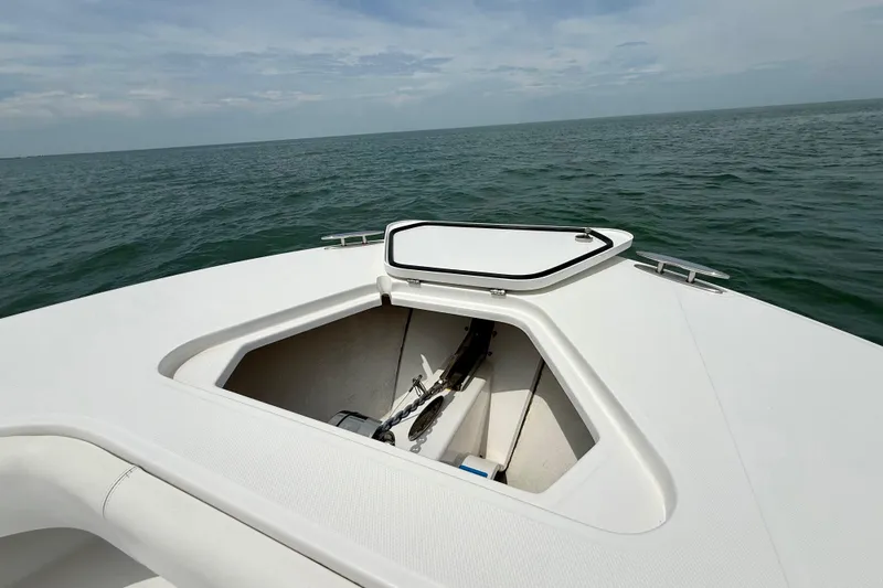 Slide: The Image of 2017 Southport 33 FE boat deck with ocean view, featuring sleek white design. - 22