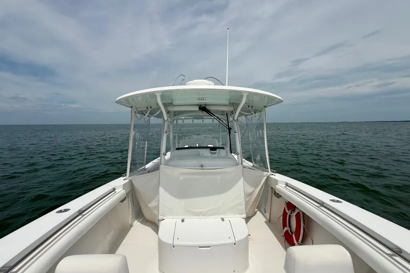 Slide: The Image of Open storage compartment on 2017 Southport 33 FE boat with life preserver nearby. - 25