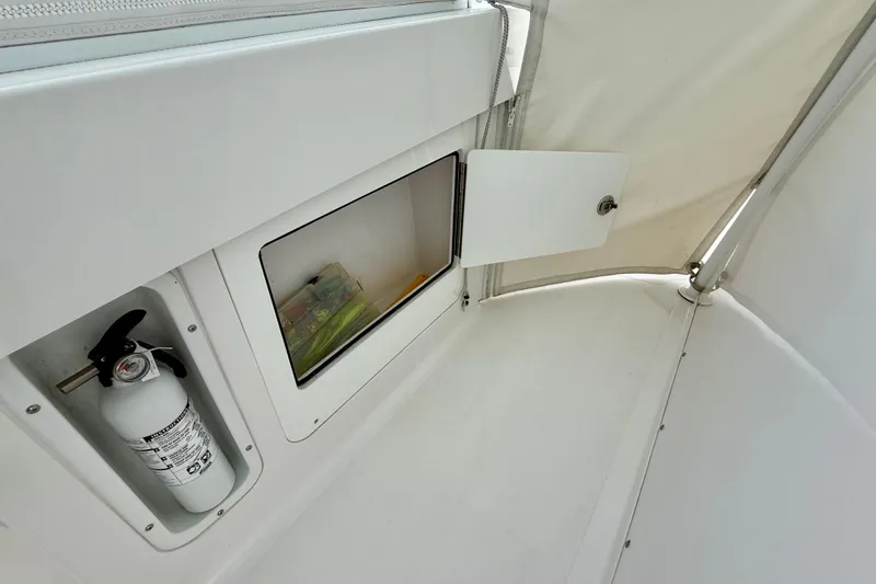 Slide: The Image of Interior storage compartment of a 2017 Southport 33 FE boat, featuring a first aid kit. - 36