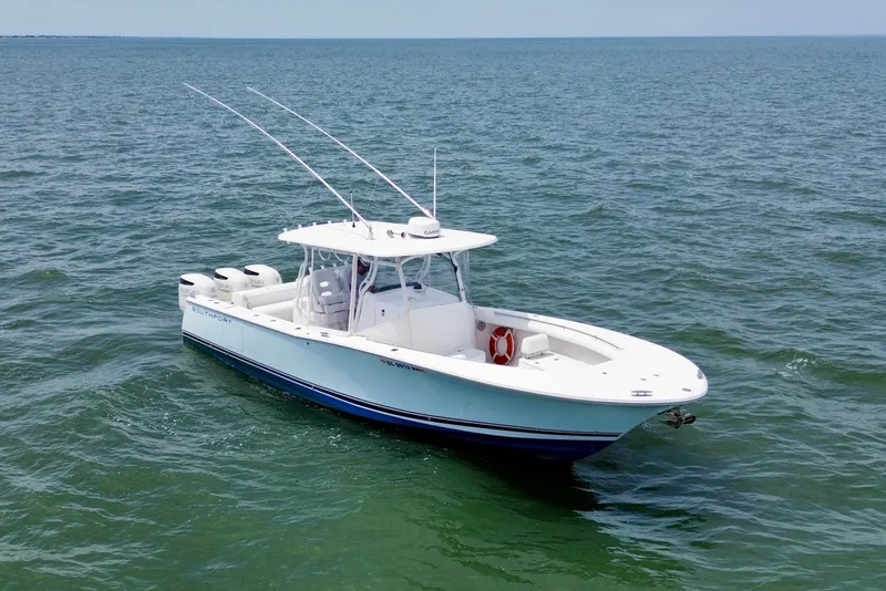 Slide: The Image of 2017 Southport 33 FE boat on calm water, featuring dual Suzuki engines. - 4