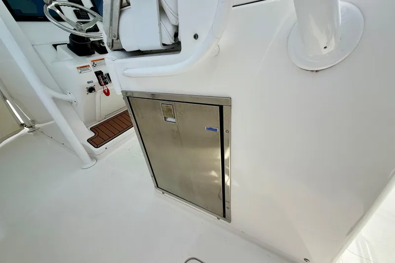 Slide: The Image of Open refrigerator on a 2017 Southport 33 FE boat, showcasing interior shelves. - 43