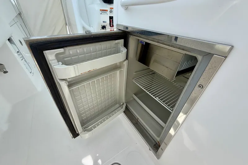 Slide: The Image of 2017 Southport 33 FE boat interior with storage compartments and white seating. - 44