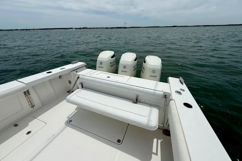 Slide: The Image of 2017 Southport 33 FE boat with triple Suzuki 300 outboard engines on open water. - 49