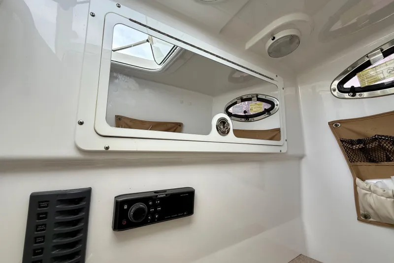 Slide: The Image of 2017 Southport 33 FE boat interior with toilet and storage area. - 54