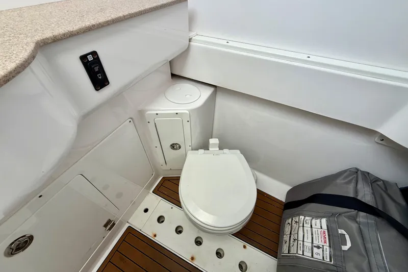 Slide: The Image of 2017 Southport 33 FE boat interior with sink, toilet, and storage compartments. - 55