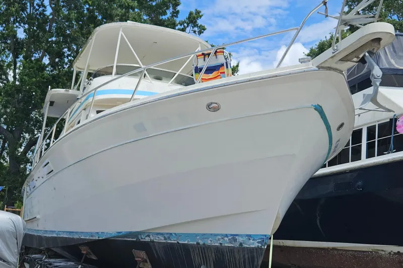The Image of 1991 Offshore Yachts 48 Yachtfisher on land, showcasing sleek design and sturdy build. - 0
