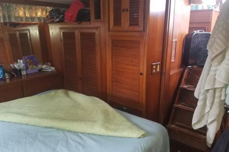 Slide: The Image of Cozy cabin interior of 1991 Offshore Yachts 48 Yachtfisher with wooden cabinetry and bedding. - 10