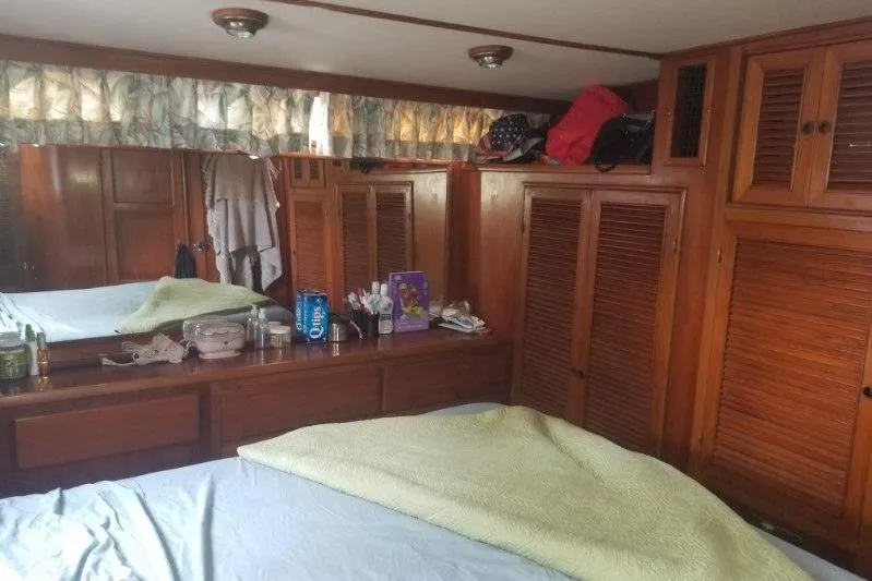 Slide: The Image of Cozy cabin interior of 1991 Offshore Yachts 48 Yachtfisher with wooden furnishings and storage. - 11