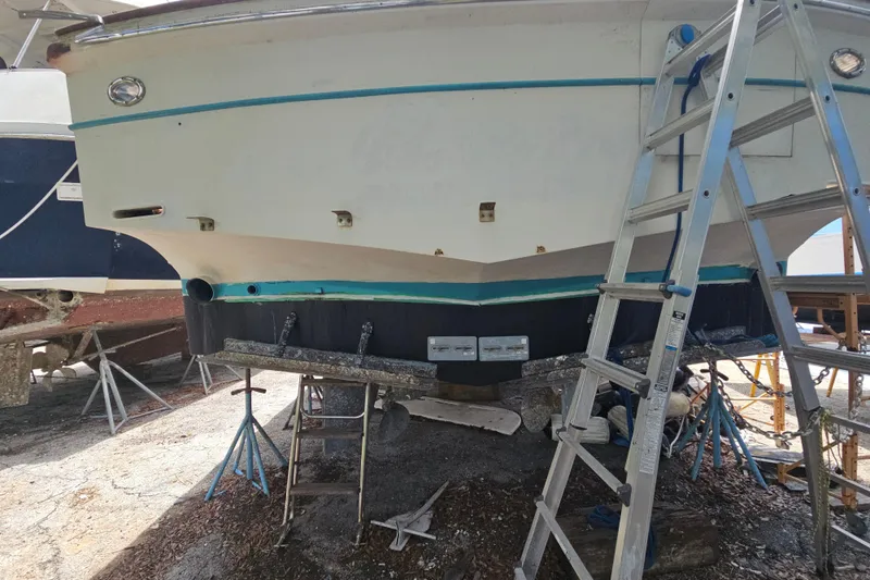 Slide: The Image of 1991 Offshore Yachts 48 Yachtfisher on dry dock with ladder and supports. - 16