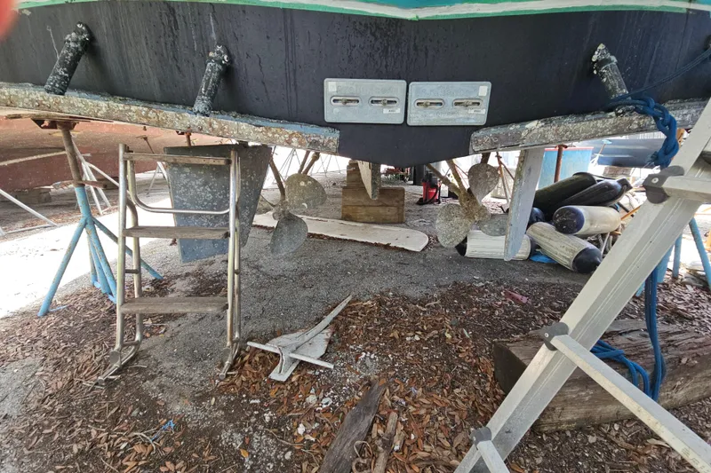Slide: The Image of 1991 Offshore Yachts 48 Yachtfisher under maintenance, showing propellers and rudders. - 17