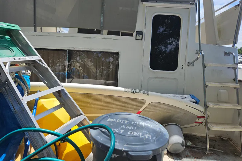Slide: The Image of 1991 Offshore Yachts 48 Yachtfisher with ladder and equipment on deck. - 19