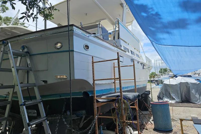 Slide: The Image of 1991 Offshore Yachts 48 Yachtfisher under maintenance with ladders and scaffolding. - 20