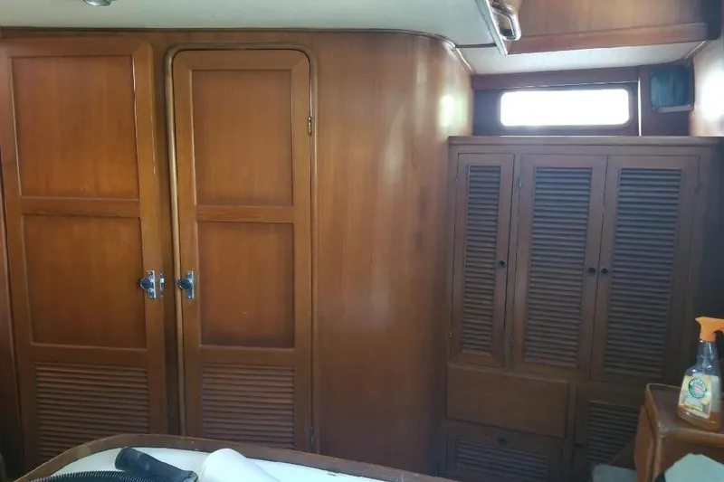 Slide: The Image of Interior of 1991 Offshore Yachts 48 Yachtfisher with wooden cabinetry and storage. - 7