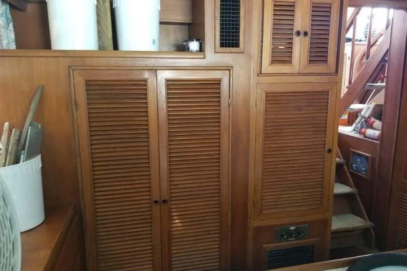 Slide: The Image of Interior of 1991 Offshore Yachts 48 Yachtfisher with wooden cabinets and stairs. - 9