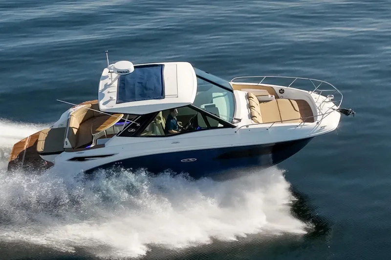 Slide: The Image of 2020 Sea Ray Sundancer 320 Coupe cruising on open water, showcasing sleek design and luxury. - 14