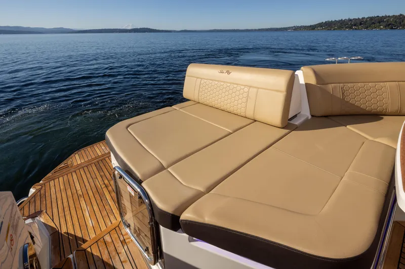 Slide: The Image of 2020 Sea Ray Sundancer 320 Coupe with luxurious tan seating on a serene lake. - 16