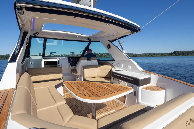 Slide: The Image of 2020 Sea Ray Sundancer 320 Coupe interior with luxurious seating and scenic water view. - 17