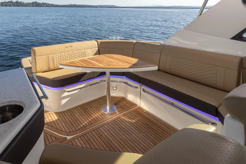 Slide: The Image of Luxurious seating area on 2020 Sea Ray Sundancer 320 Coupe yacht with elegant wood table. - 18