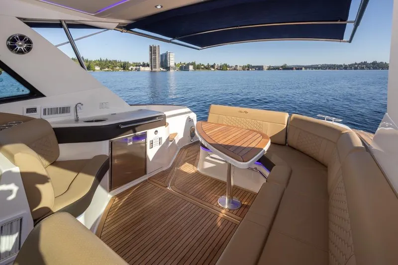 Slide: The Image of 2020 Sea Ray Sundancer 320 Coupe interior with luxurious seating and scenic water view. - 20