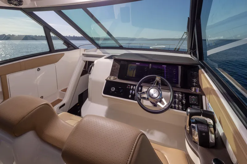 Slide: The Image of 2020 Sea Ray Sundancer 320 Coupe helm with modern controls and panoramic water view. - 24