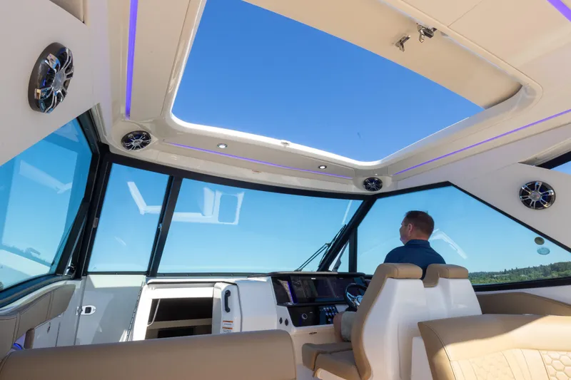 Slide: The Image of Interior view of 2020 Sea Ray Sundancer 320 Coupe with panoramic windows and modern helm. - 26