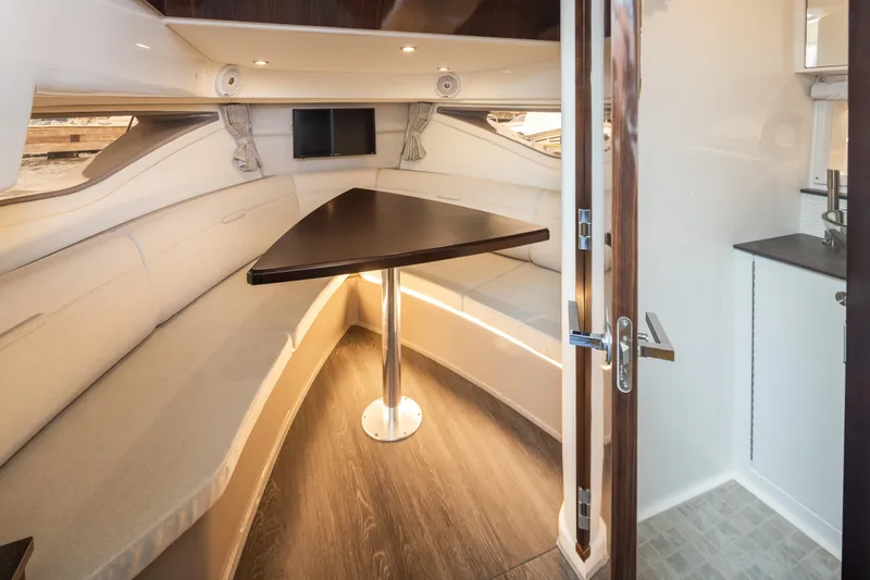 Slide: The Image of Interior of 2020 Sea Ray Sundancer 320 Coupe with cozy seating and table. - 28