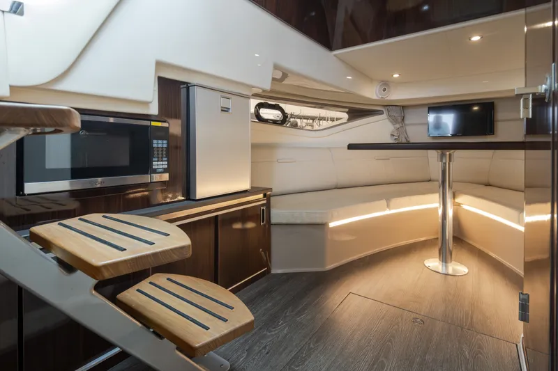 Slide: The Image of Interior of 2020 Sea Ray Sundancer 320 Coupe with modern kitchenette and cozy seating area. - 30