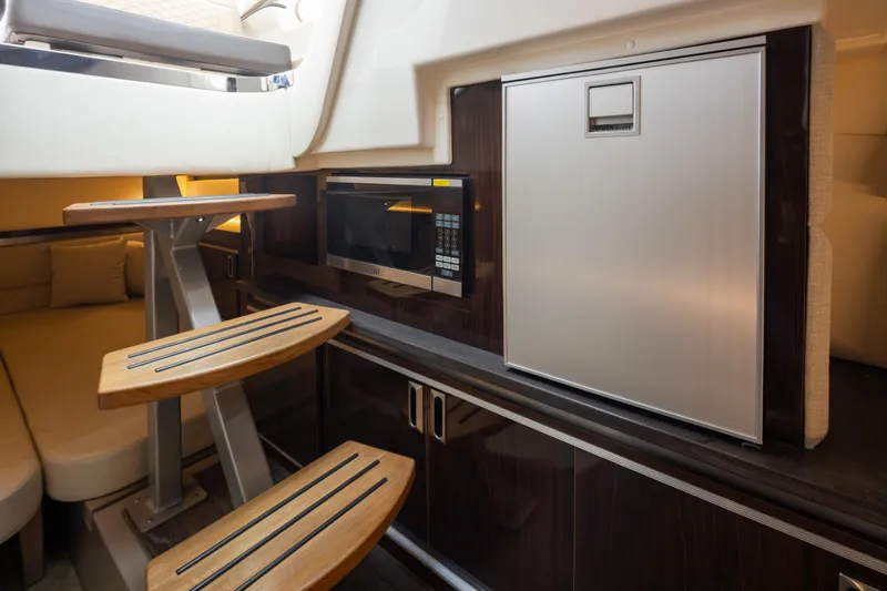 Slide: The Image of Interior of 2020 Sea Ray Sundancer 320 Coupe with kitchenette and seating area. - 32