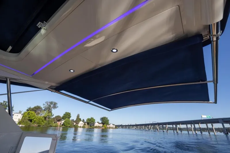 Slide: The Image of 2020 Sea Ray Sundancer 320 Coupe with retractable awning on a scenic waterway. - 41