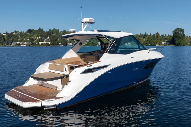 Slide: The Image of 2020 Sea Ray Sundancer 320 Coupe on a serene lake, showcasing sleek design and luxury. - 6